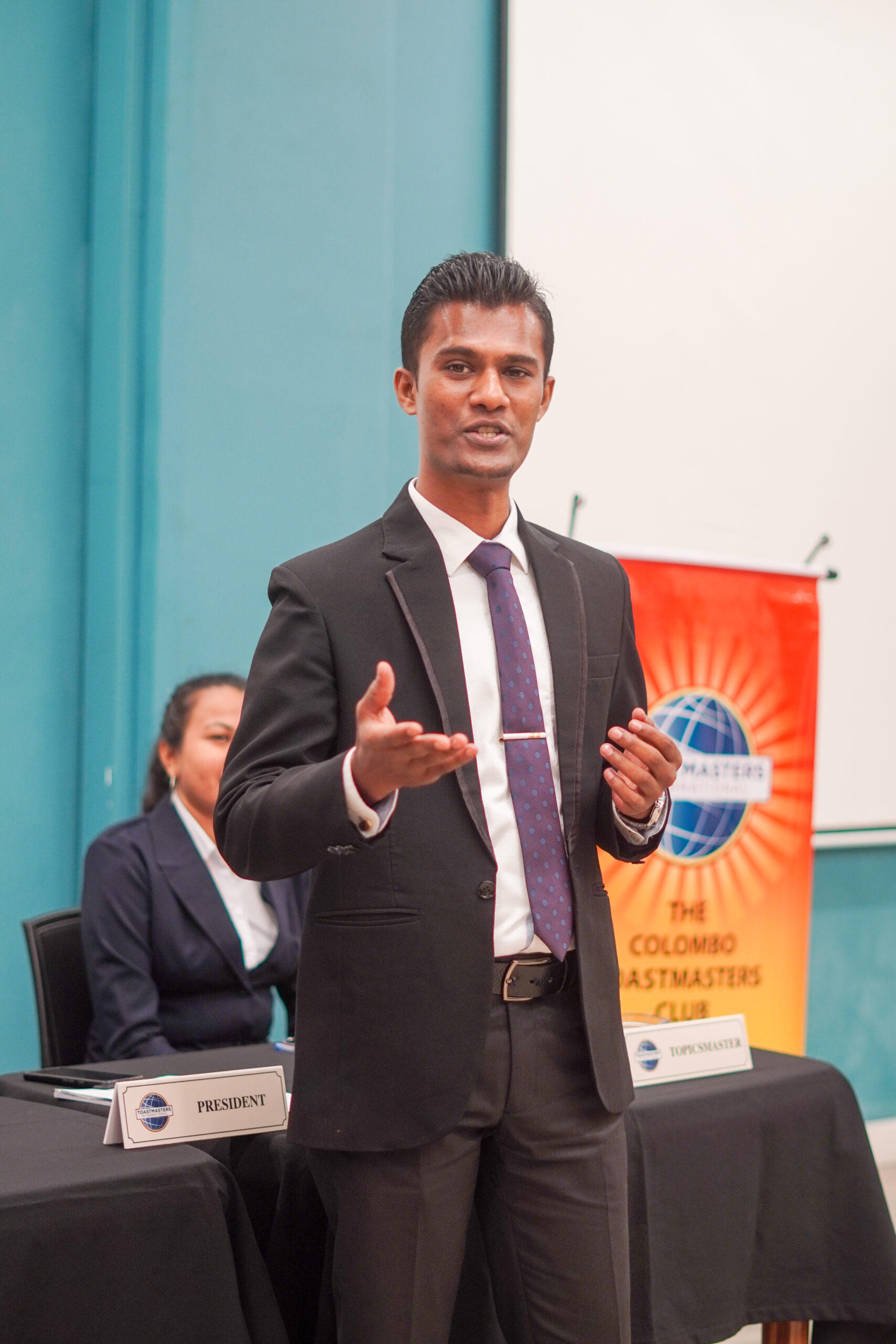 A boy confidently giving a speech at the speechcraft program