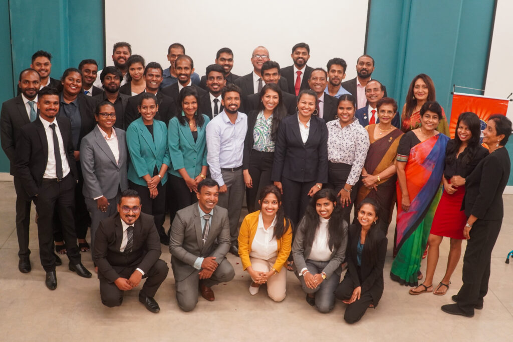 A group of people smiling and posing for a photo at the speechcraft event